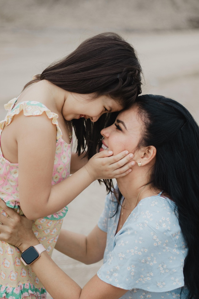 warm mother and daughter hug outdoors